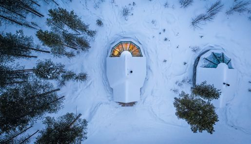 Aerial view of an aurora cabin in the snowy wilderness at Aurora Village in Finnish Lapland