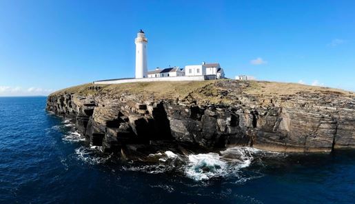 The view of Cantick Head Lighthouse from the sea in Orkney in Scotland