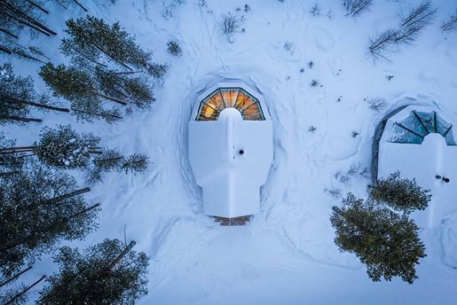 Ariel view of an aurora cabin in the snowy wilderness at Aurora Village in Finnish Lapland