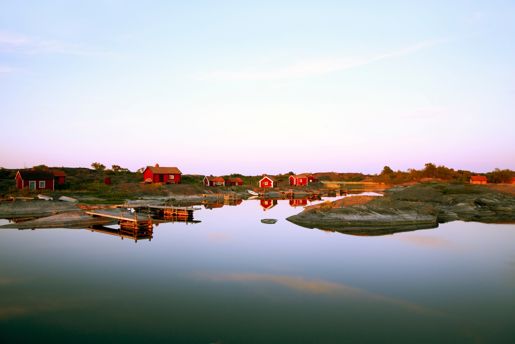 Red houses on the river bank in Sweden in summer