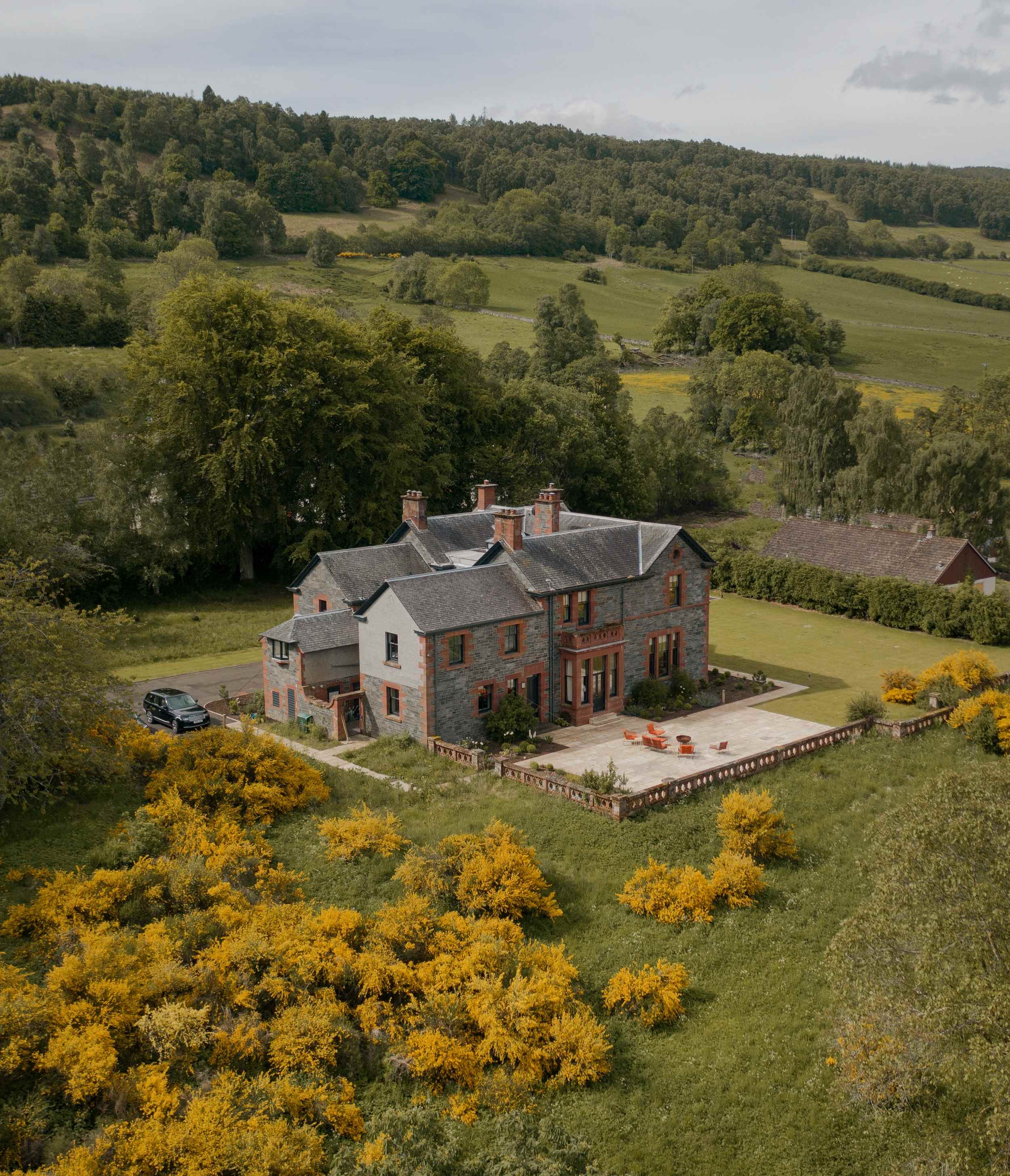 Ariel view of Dun Aluinn House and the woodlands beyond in Perthshire in Scotland