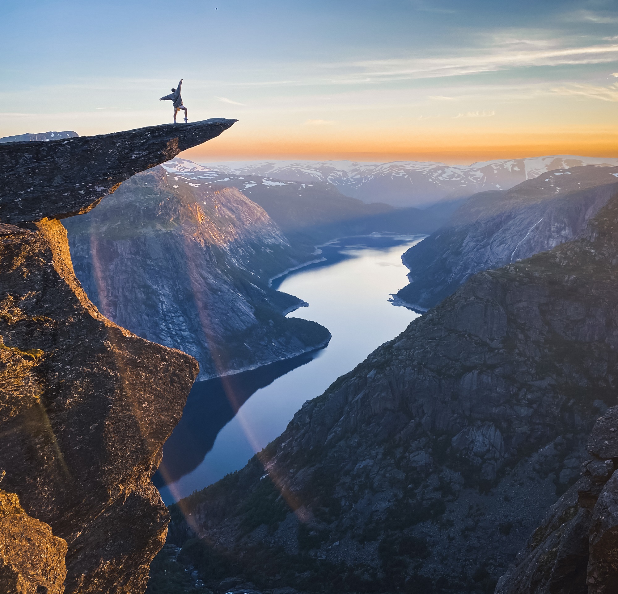 Sunset over Trolltunga cliff in Norway