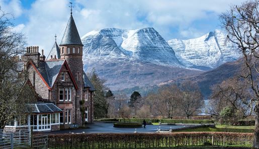 External view of The Torridon Resort with the snow-capped mountains beyond in the Scottish Highlands