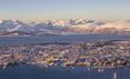 Birds-eye view of the beautiful cityscape with the dramatic mountain range behind in Tromsø in Norway.