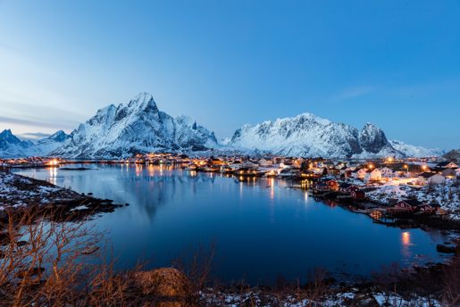 Snowy mountains overlooking a fjord at dusk in Norwegian Lapland