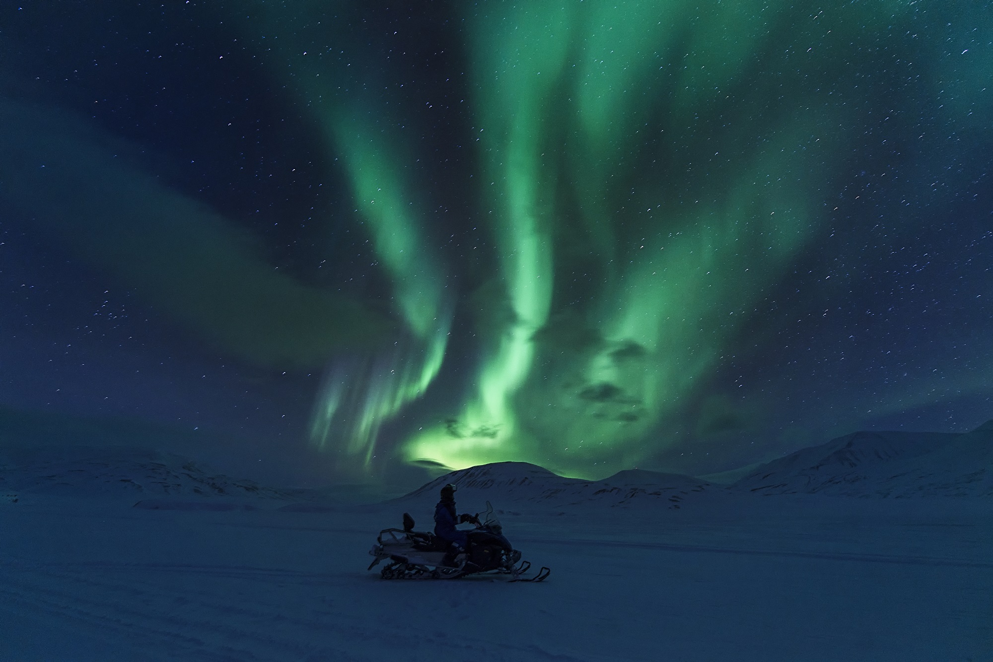Snowmobiling experience under the northern lights in Longyearbyen, Svalbard