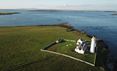 Ariel view over Cantick Head Lighthouse and the sea beyond on Orkney in Scotland