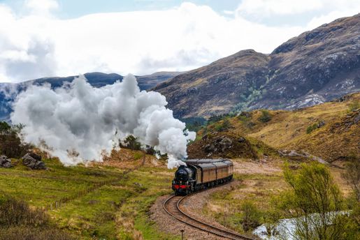 View of the the Jacobite stream train travelling through the Scottish countryside to Mallaig in the Highlands