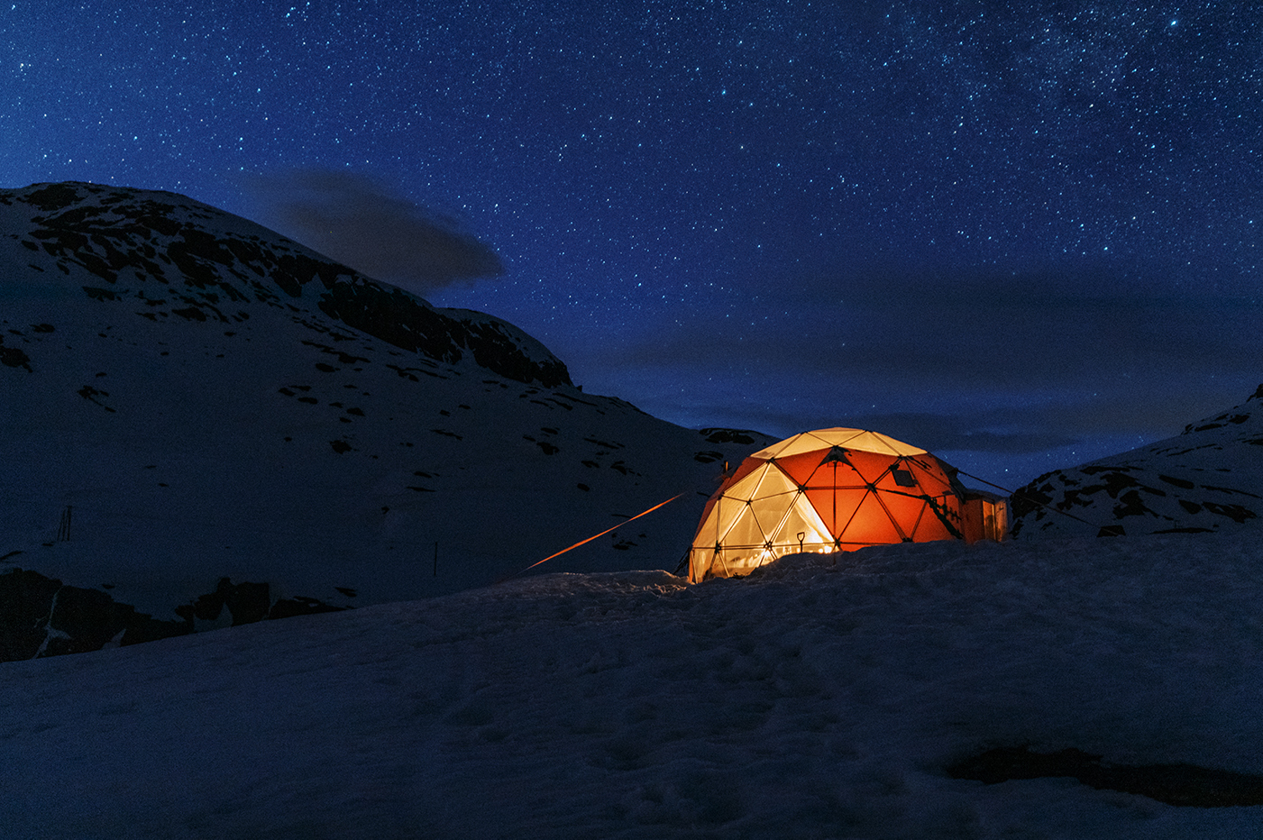 A star filled sky over the dome tent at Basecamp Trolltunga, Norway