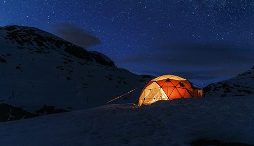 A star filled sky over the dome tent at Basecamp Trolltunga, Norway