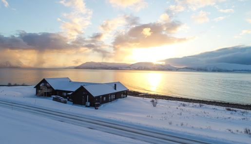 View of the Lyngen Experience over the water at sundown, Norway
