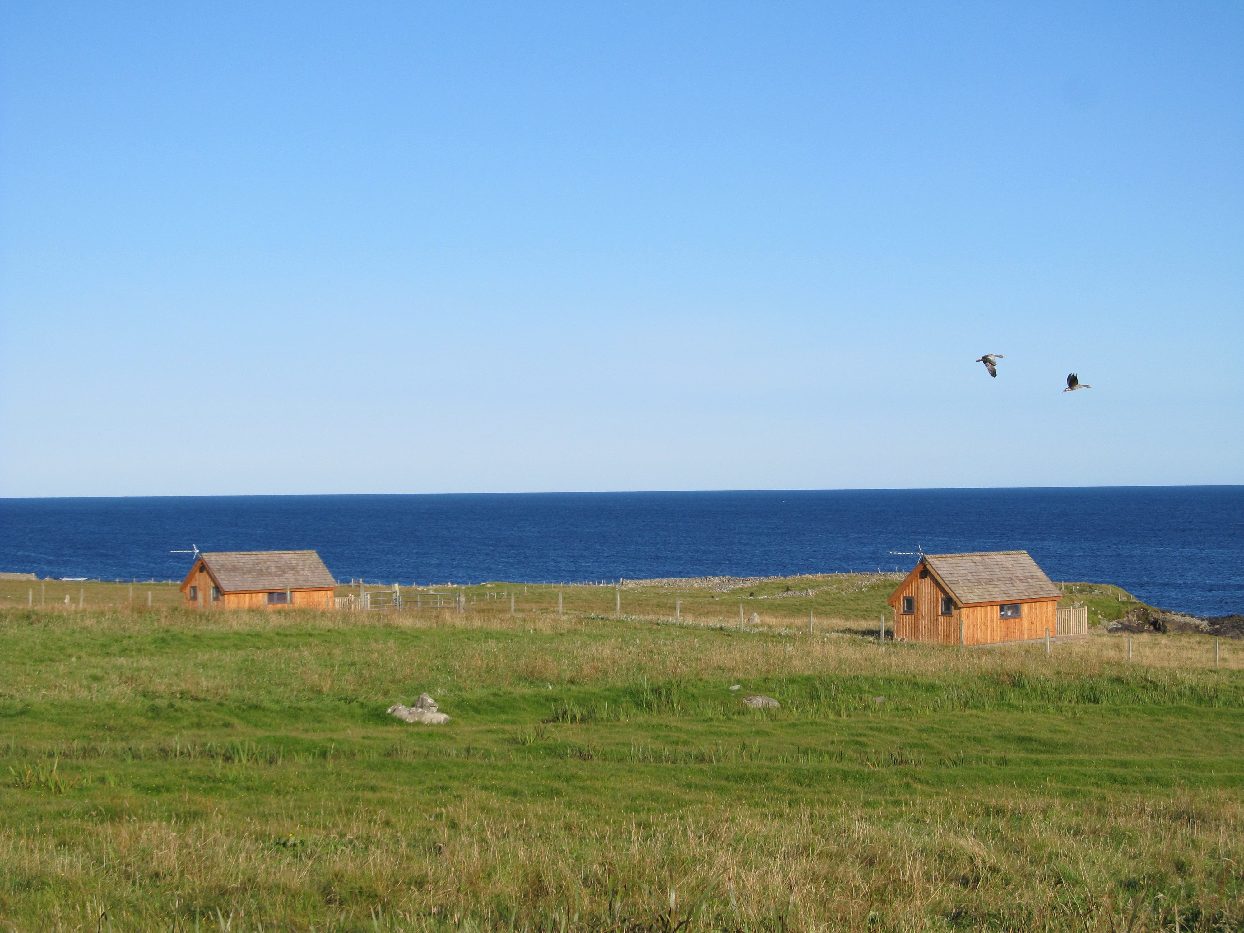 The Hebridean Huts on a sunny day overlooking the ocean on the Isle of Lewis in the Outer Hebrides in Scotland